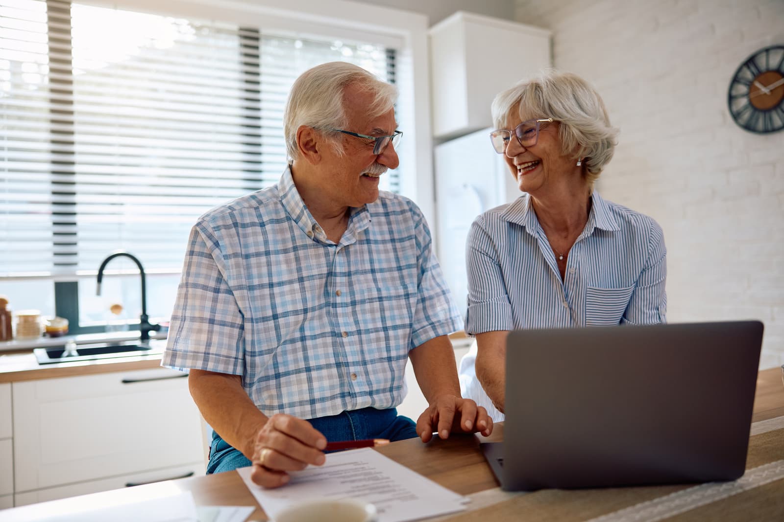 Happy senior couple reviewing their home finances