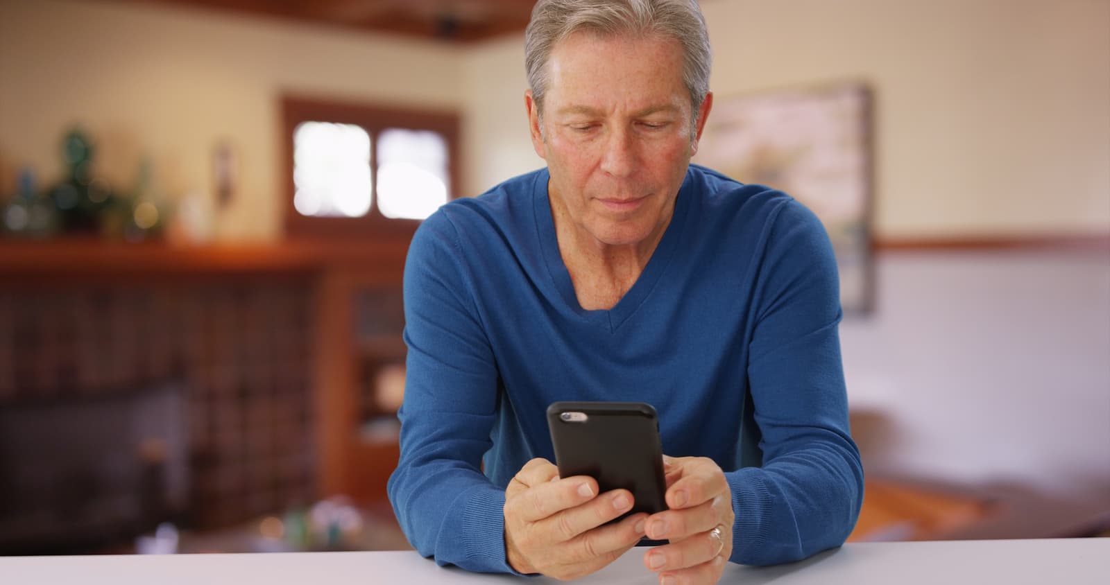 Good looking caucasian male looking at cell phone