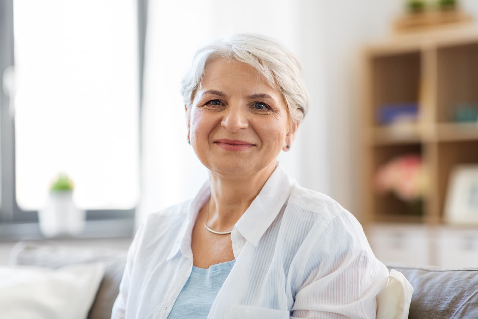 Emotion, age and people concept - portrait of happy senior woman laughing