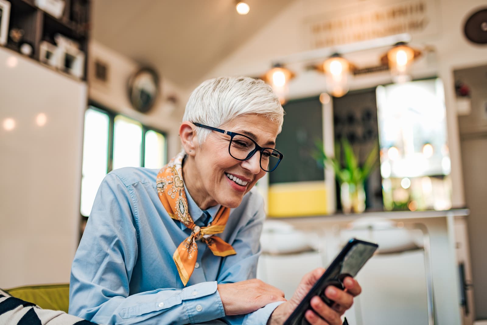 A senior woman smiling at her phone