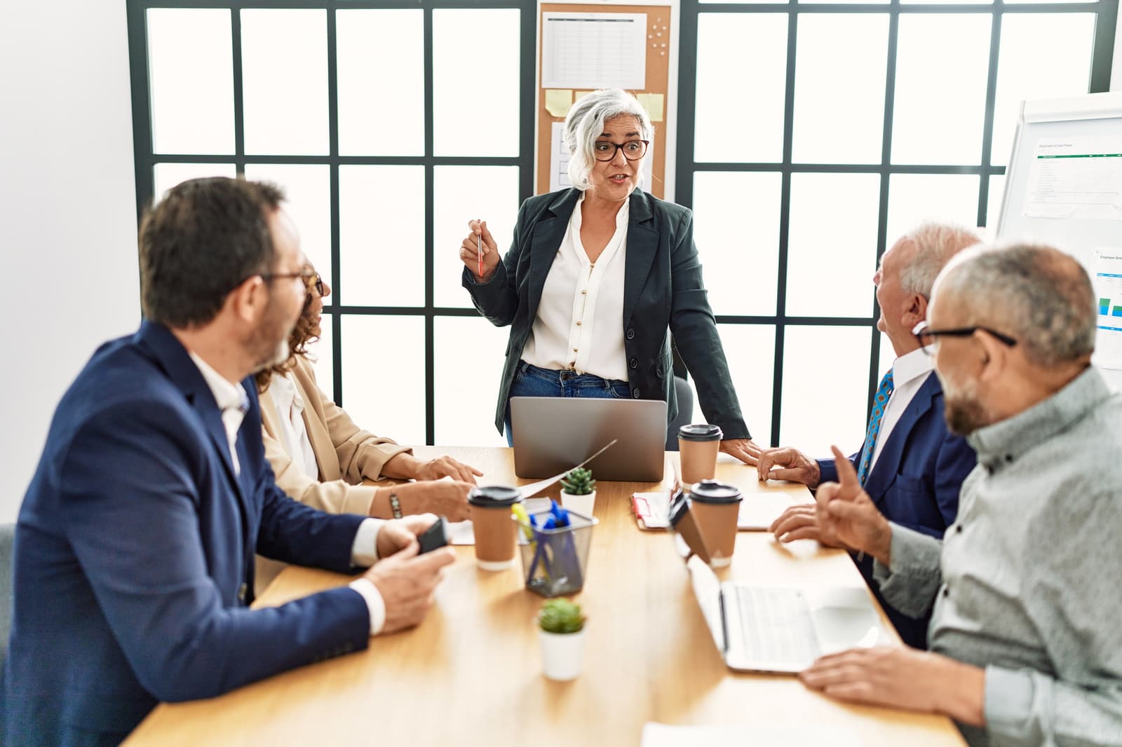 A team of experienced colleagues listening in a meeting