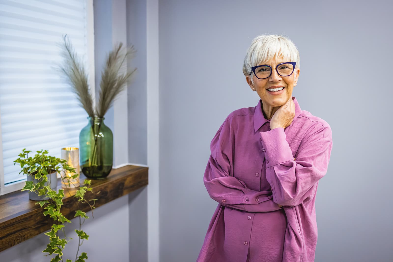 Happy smiling mature woman in her sixties with trendy white short hair