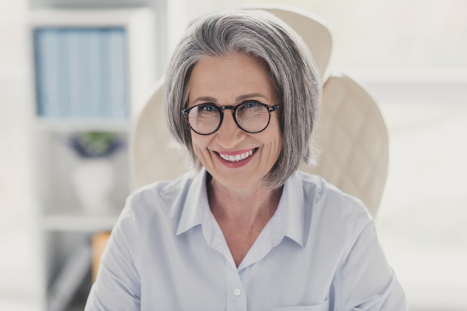 Photo portrait of mature senior woman employee experience expert toothy beaming smile businesswoman sitting at