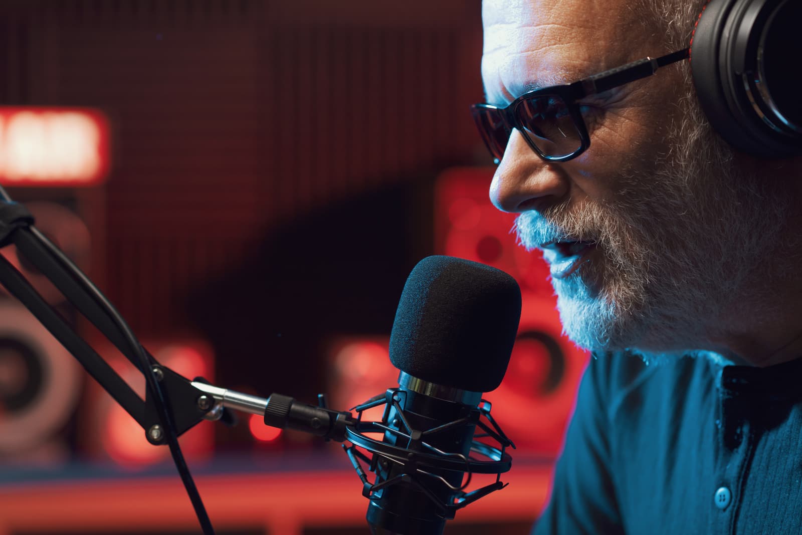 A presenter talking into a studio microphone