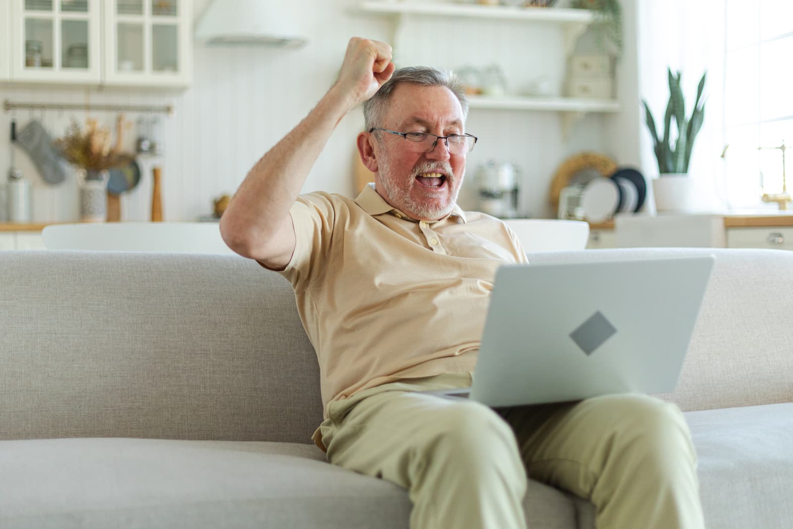 A senior man celebrating good news