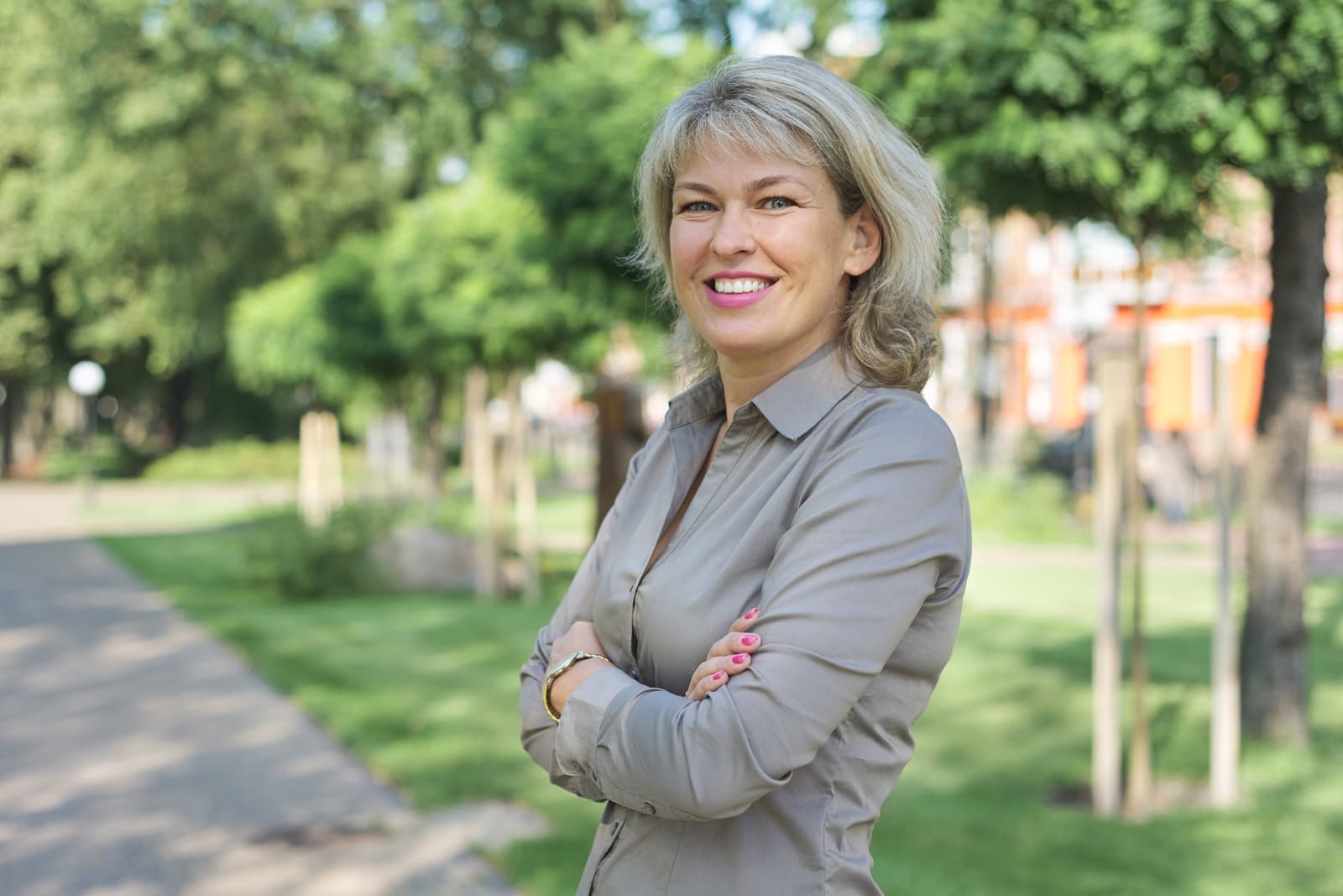 Outdoor portrait of positive mature middle-aged woman
