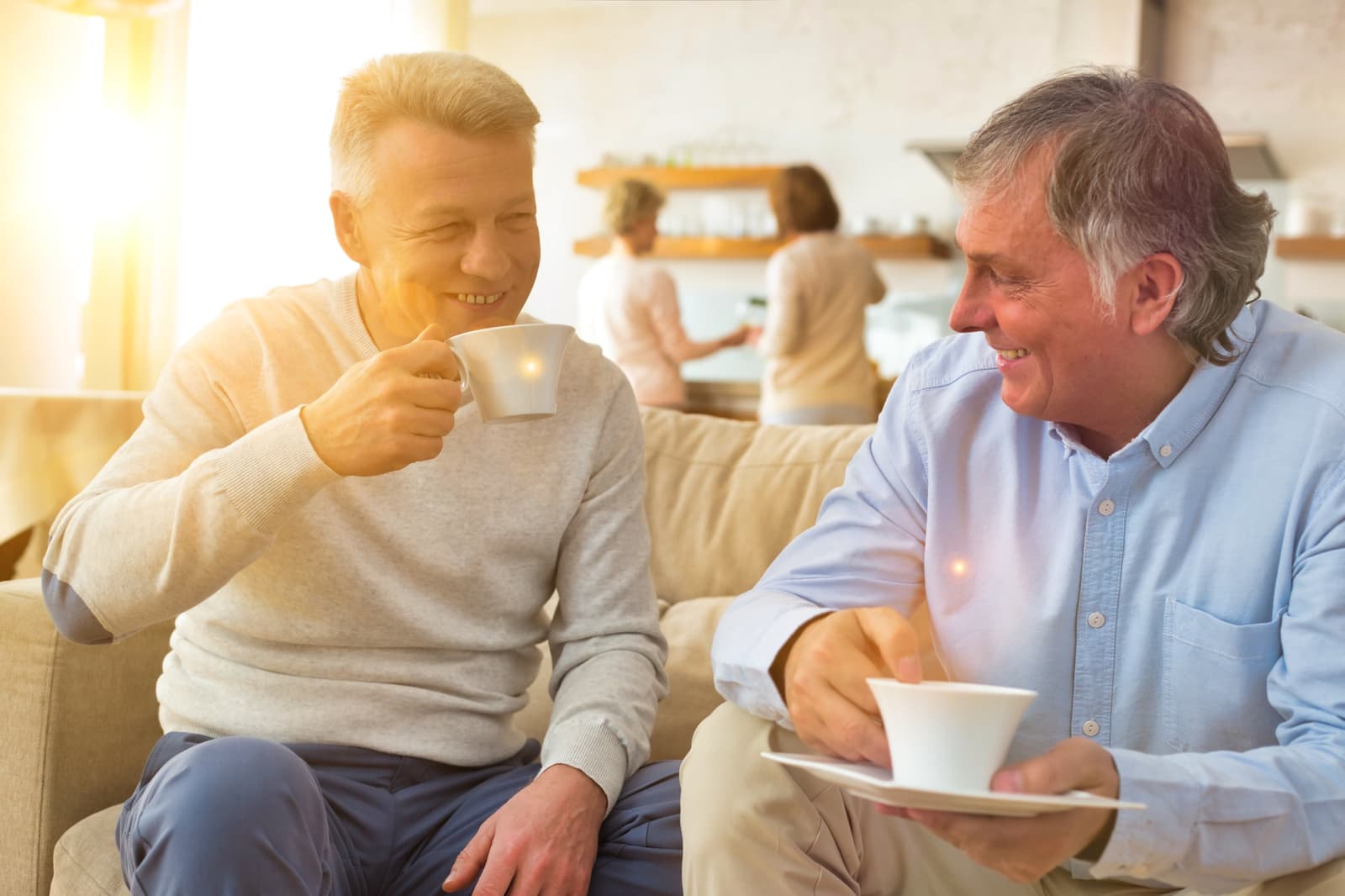 Two mature men talking over coffee