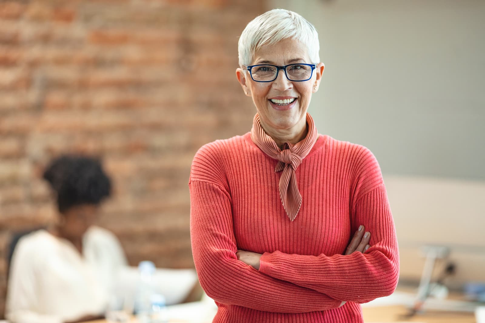 Close-up portrait of mature business woman standing at office