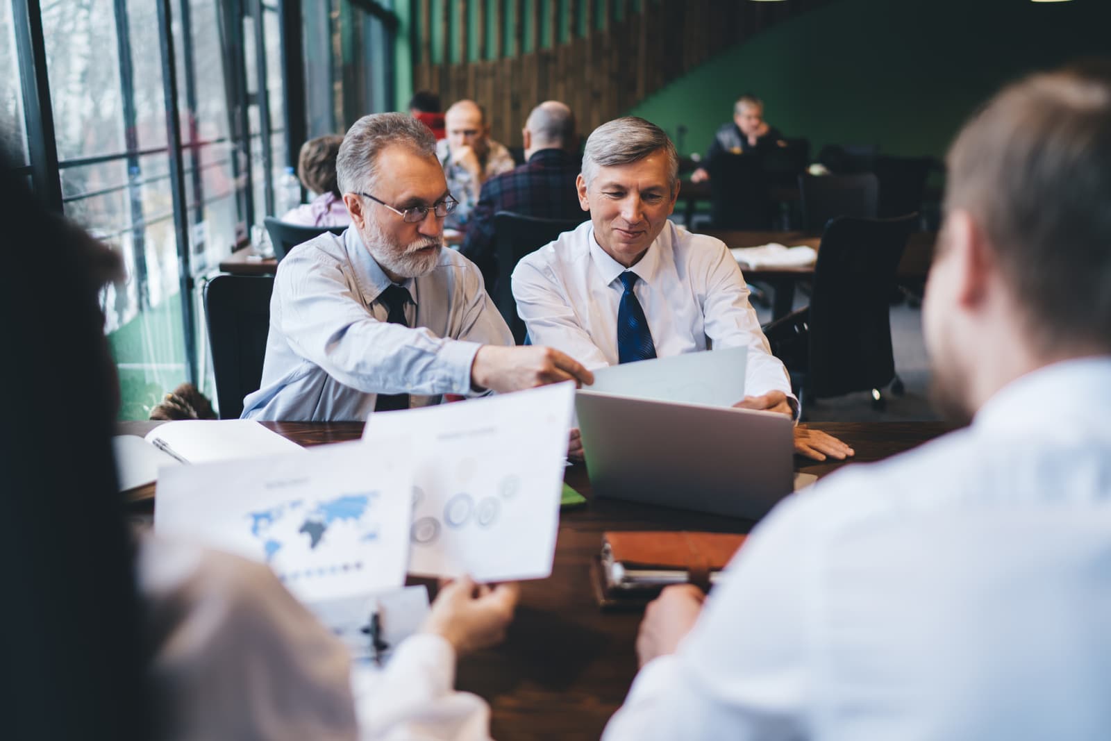 Senior businessmen talking together at a conference table