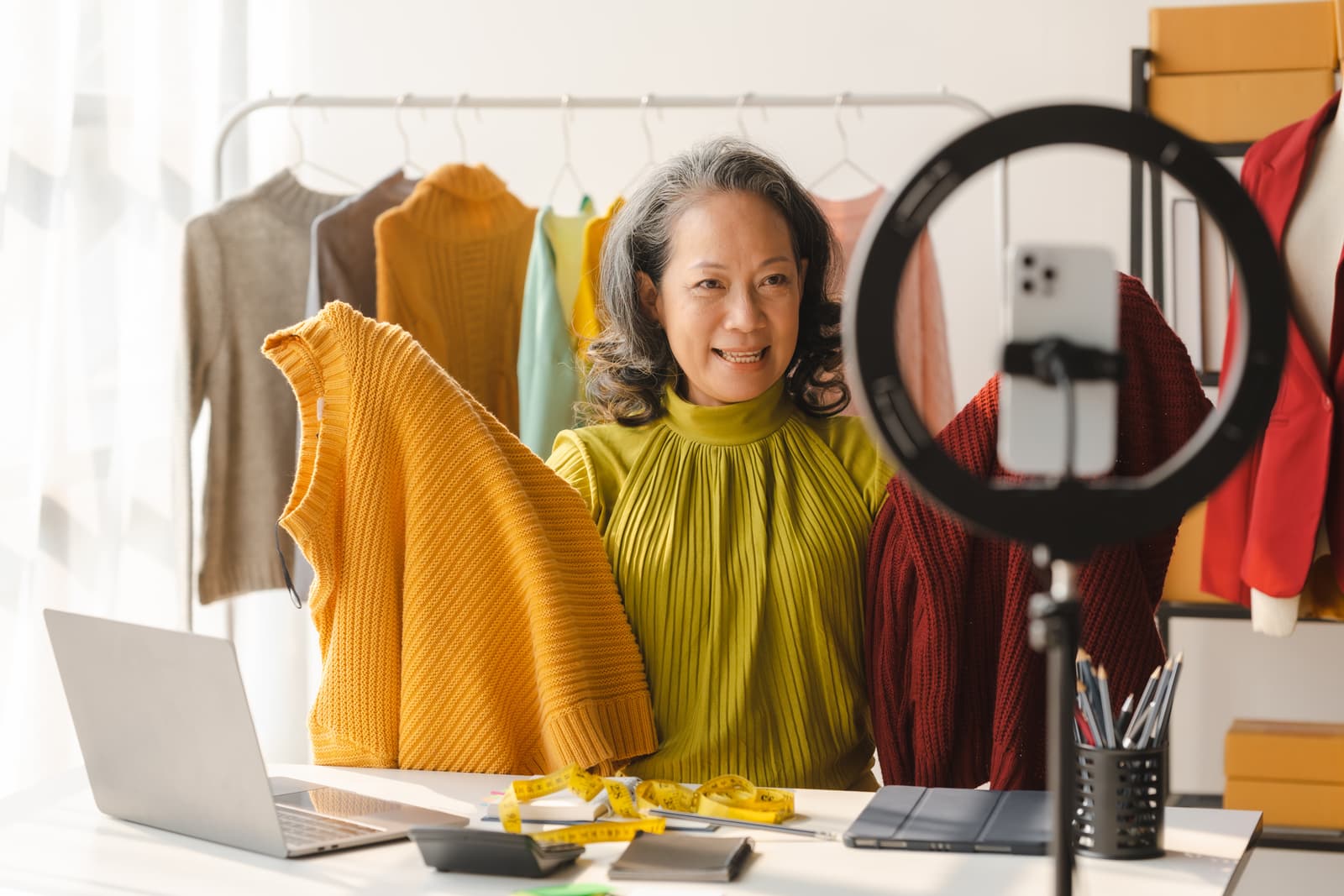 Elderly Asian business woman home office SMEs owner of online clothing store