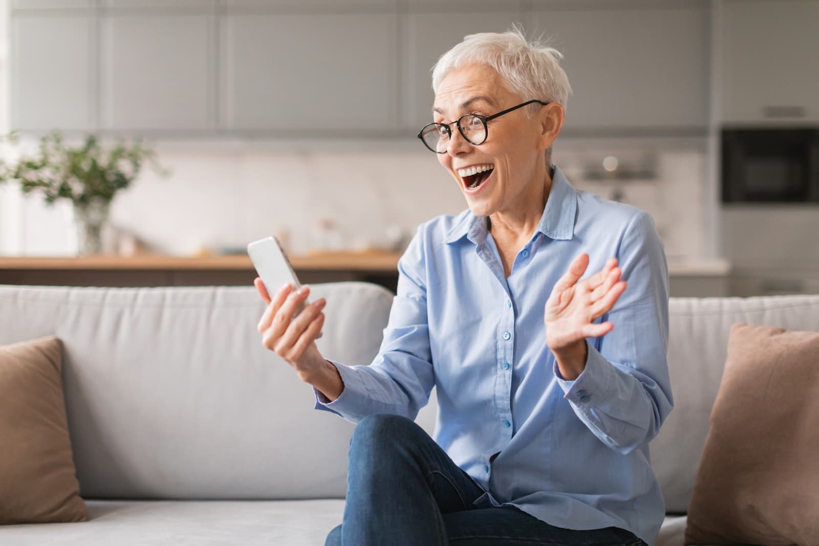 A mature woman delighted by a message on her phone