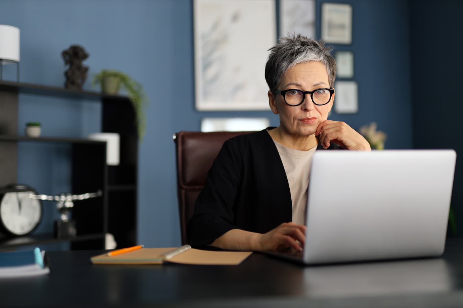 Mature professional working on a laptop, reflecting a blend of experience and modern digital competence